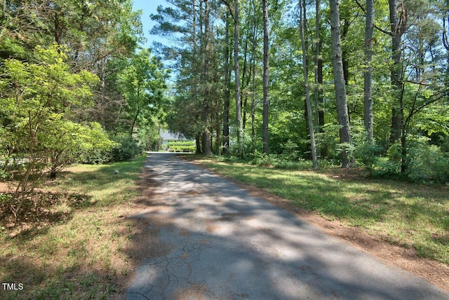 view of road featuring a forest view