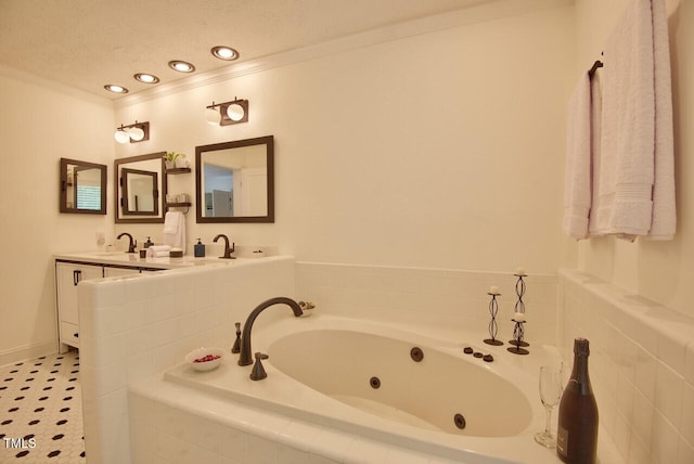 full bathroom with double vanity, a whirlpool tub, a textured ceiling, crown molding, and a sink