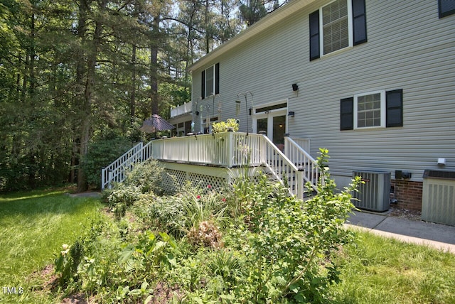 back of house featuring stairs, a yard, central AC unit, and a wooden deck