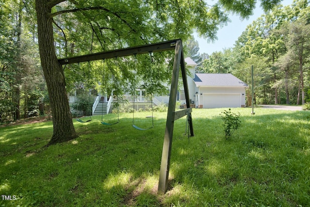 view of yard with a garage and stairway