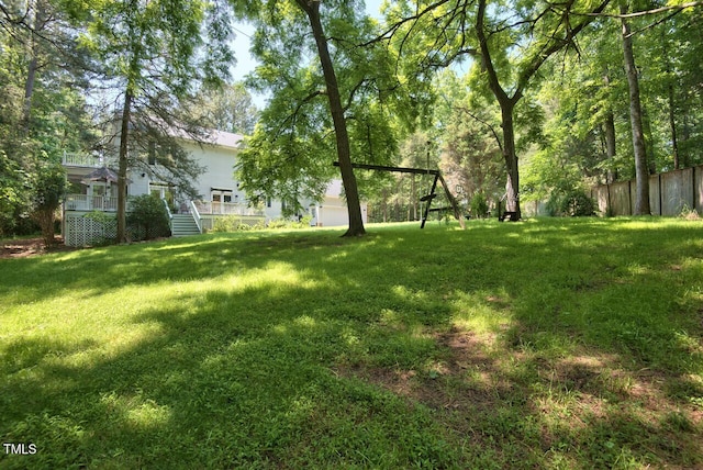 view of yard with fence and a wooden deck