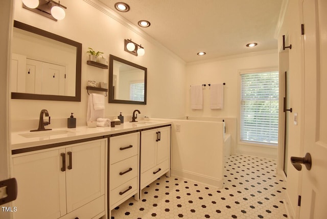 full bathroom with a sink, crown molding, double vanity, and a bath