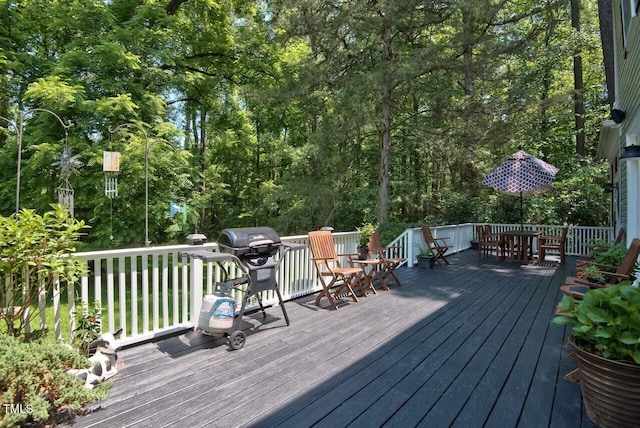 deck featuring a grill and outdoor dining space