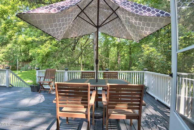 wooden terrace featuring outdoor dining area