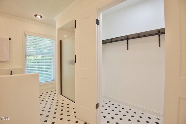 full bath featuring a walk in closet, a shower stall, baseboards, ornamental molding, and recessed lighting