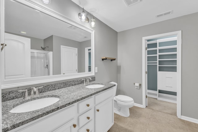 bathroom with vanity, toilet, and walk in shower