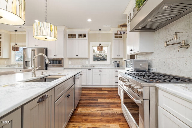 kitchen featuring sink, white cabinets, stainless steel appliances, and wall chimney range hood