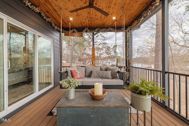 sunroom / solarium with ceiling fan and wooden ceiling