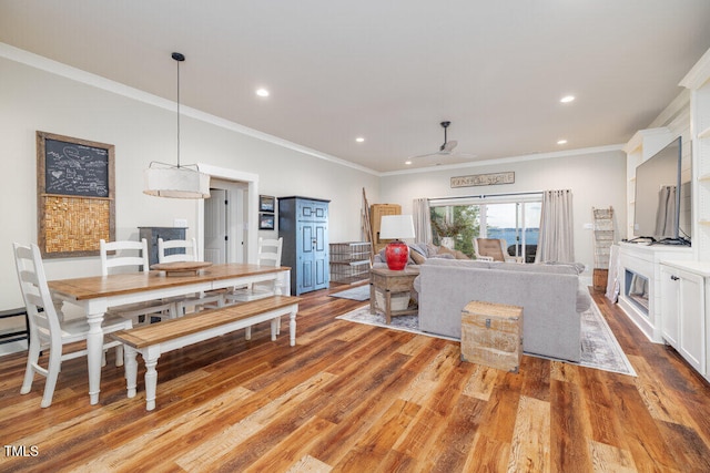 living room with ceiling fan, light hardwood / wood-style flooring, and ornamental molding