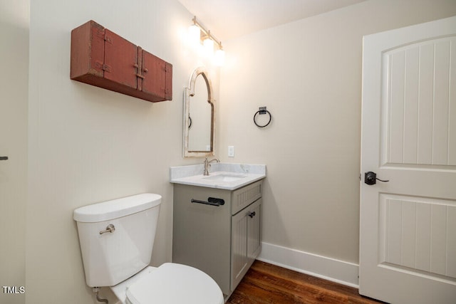 bathroom with hardwood / wood-style flooring, vanity, and toilet