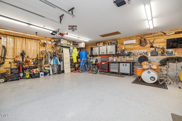 garage with a workshop area and a garage door opener