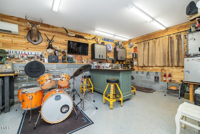 garage with a workshop area and a wall unit AC