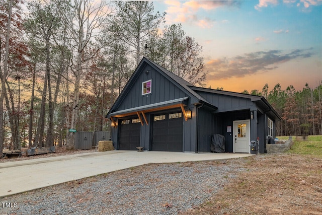 view of garage at dusk