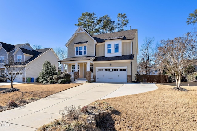 craftsman inspired home featuring a garage, board and batten siding, fence, and concrete driveway