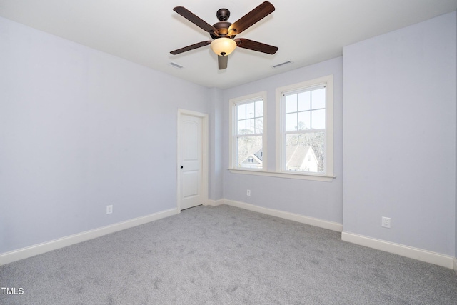 unfurnished room featuring light carpet, ceiling fan, visible vents, and baseboards