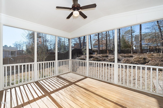 unfurnished sunroom with vaulted ceiling and a ceiling fan