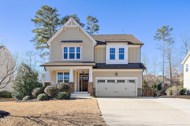 craftsman inspired home with a porch, an attached garage, board and batten siding, stone siding, and driveway