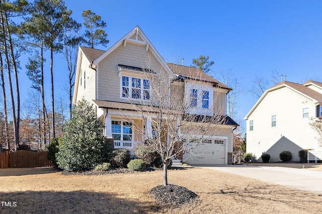 view of front of property with a garage, fence, and concrete driveway