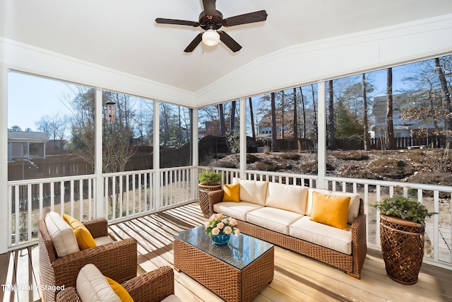 sunroom / solarium with a ceiling fan and vaulted ceiling