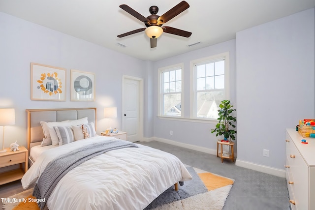 carpeted bedroom featuring baseboards, visible vents, and a ceiling fan