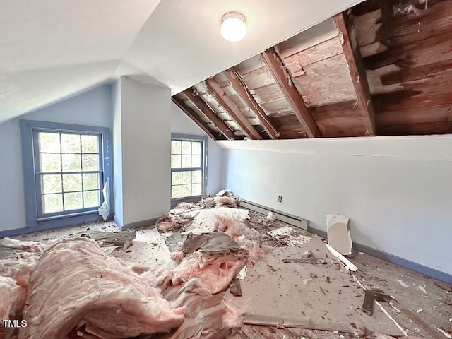 additional living space with a baseboard radiator and lofted ceiling