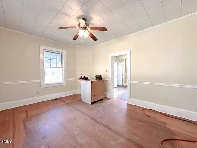 empty room featuring light hardwood / wood-style flooring, ceiling fan, and crown molding