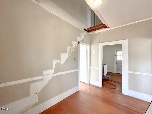 interior space with hardwood / wood-style floors and crown molding