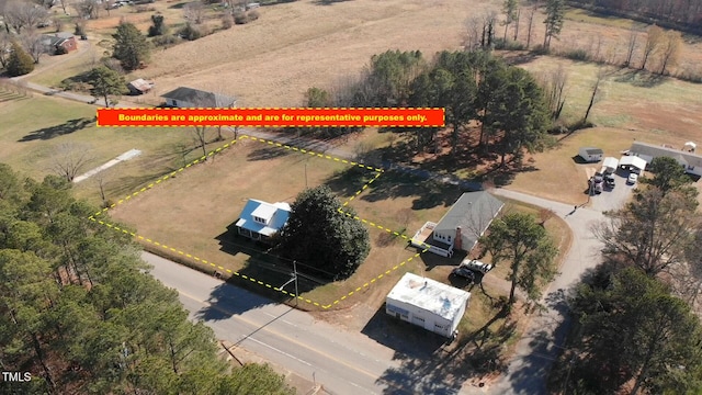 birds eye view of property with a rural view