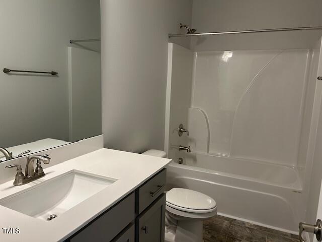 full bathroom with vanity, shower / bath combination, and toilet