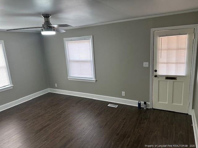 1016 E 8th St, Lumberton, NC 28358 - spare room with ornamental molding, dark wood-type flooring, and ceiling fan