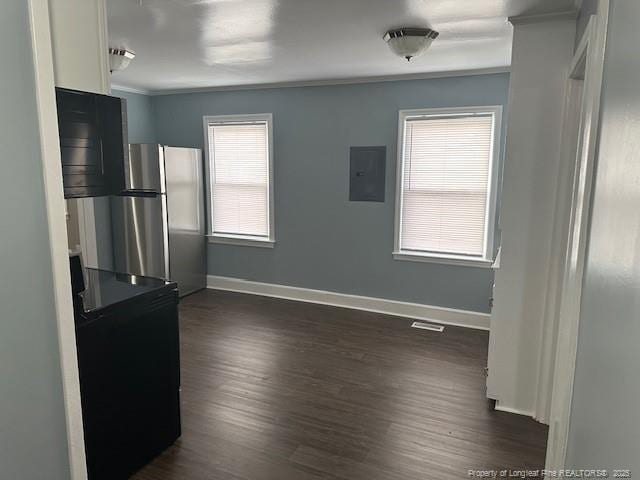 1016 E 8th St, Lumberton, NC 28358 - interior space featuring dark hardwood / wood-style floors, stainless steel fridge, electric panel, and white cabinets