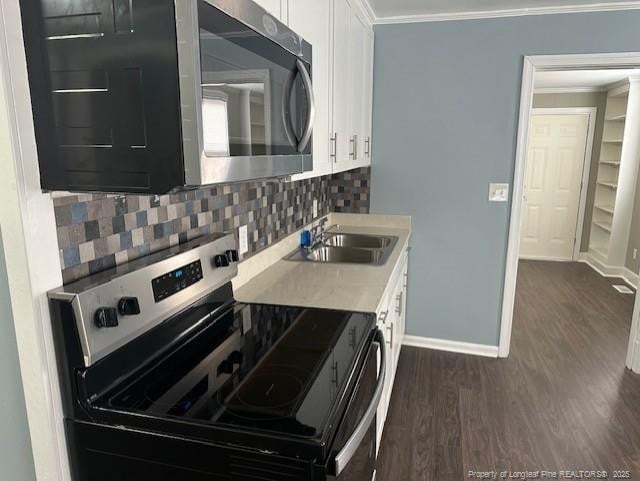 1016 E 8th St, Lumberton, NC 28358 - kitchen with white cabinetry, appliances with stainless steel finishes, crown molding, and sink