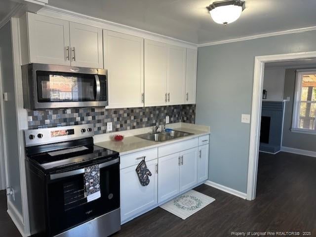 1016 E 8th St, Lumberton, NC 28358 - kitchen featuring stainless steel appliances, white cabinetry, sink, and backsplash