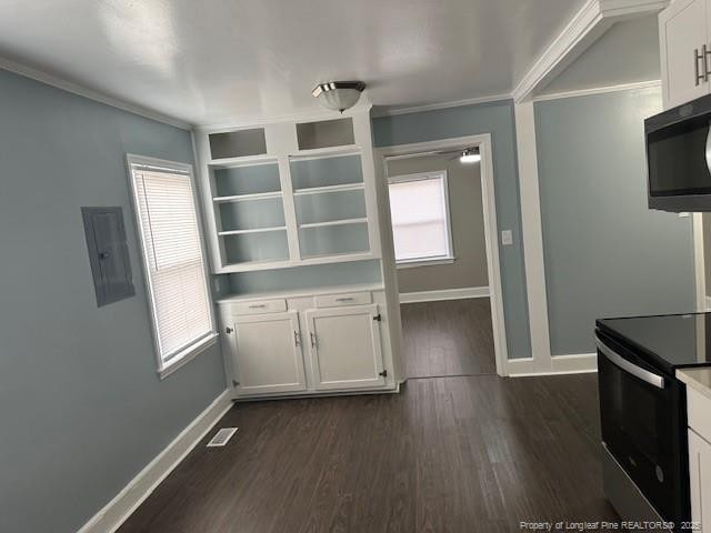 1016 E 8th St, Lumberton, NC 28358 - kitchen featuring stainless steel electric range oven, white cabinets, ornamental molding, electric panel, and dark wood-type flooring