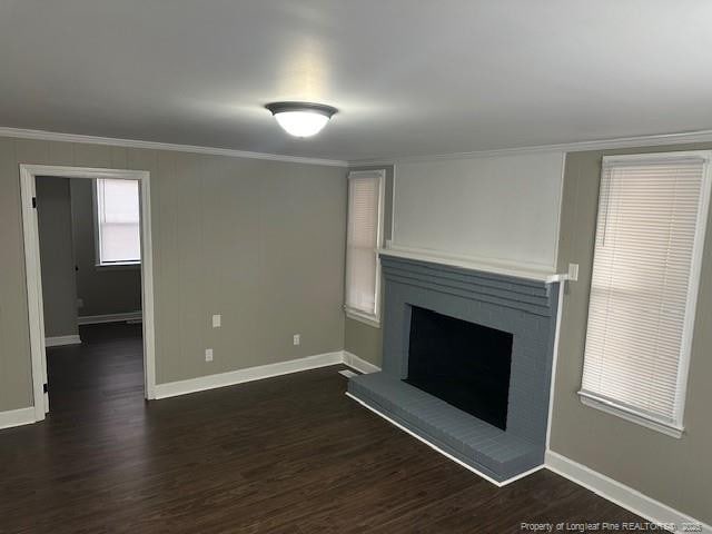 1016 E 8th St, Lumberton, NC 28358 - unfurnished living room with dark hardwood / wood-style flooring, a brick fireplace, and ornamental molding