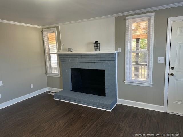 1016 E 8th St, Lumberton, NC 28358 - unfurnished living room with crown molding, dark hardwood / wood-style floors, and a fireplace