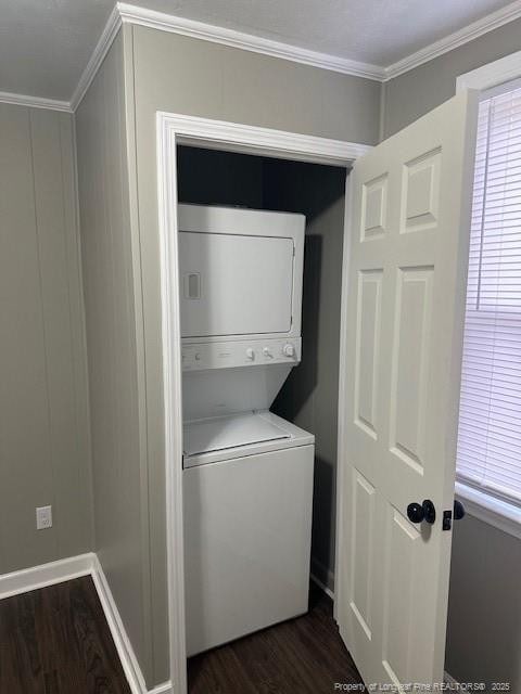 1016 E 8th St, Lumberton, NC 28358 - clothes washing area with stacked washer / dryer, ornamental molding, and dark wood-type flooring