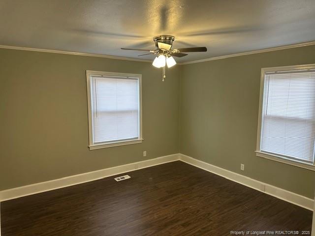 1016 E 8th St, Lumberton, NC 28358 - spare room featuring crown molding, dark wood-type flooring, and ceiling fan