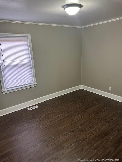 1016 E 8th St, Lumberton, NC 28358 - spare room with crown molding and dark hardwood / wood-style floors