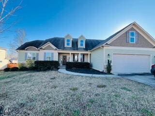 view of front of property featuring a garage and a front lawn