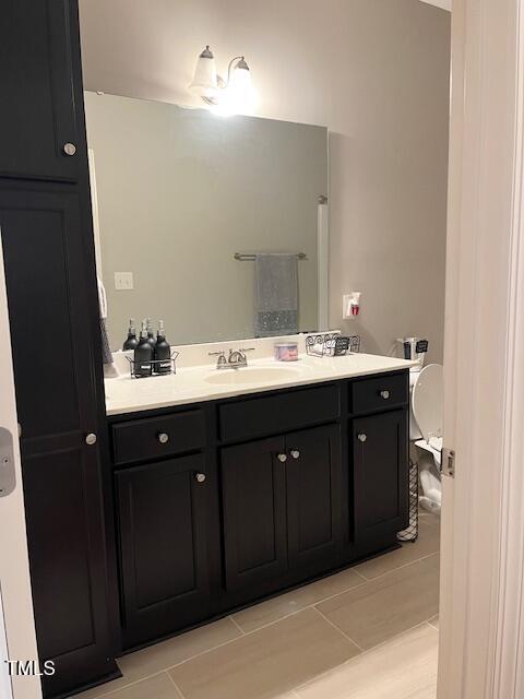 bathroom with tile patterned floors and vanity