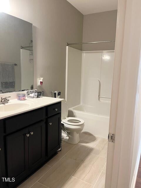 full bathroom featuring tile patterned floors, vanity, toilet, and bathing tub / shower combination