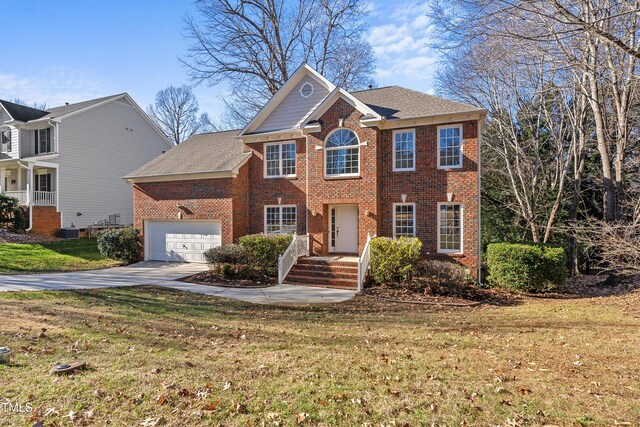 view of front of property featuring a garage and a front lawn