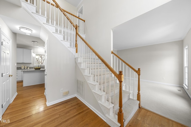 stairway featuring hardwood / wood-style flooring