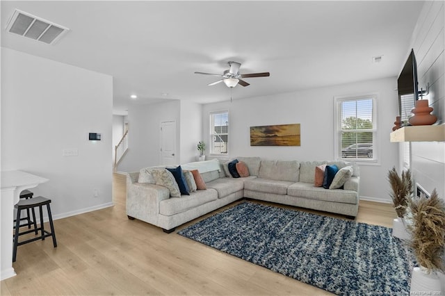 living room with ceiling fan and hardwood / wood-style floors