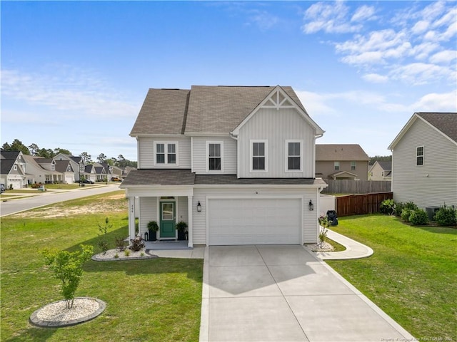 view of front of property with a garage, fence, driveway, a front lawn, and board and batten siding