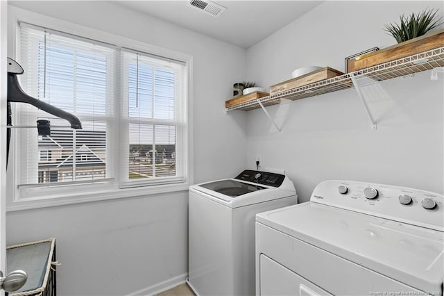 laundry area with washing machine and dryer, laundry area, and visible vents