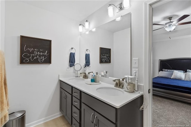 bathroom with ensuite bathroom, double vanity, ceiling fan, and a sink