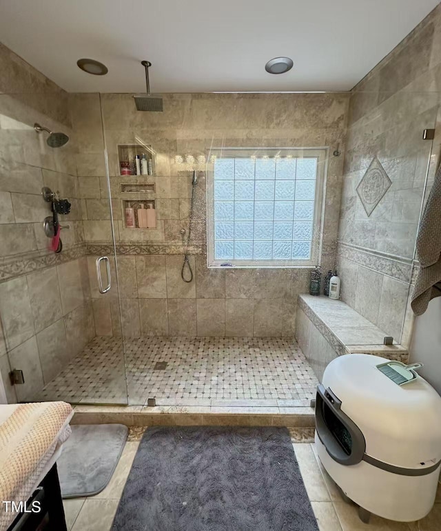 bathroom featuring tile patterned flooring and a shower with shower door