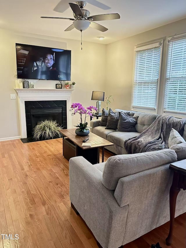 living room featuring hardwood / wood-style floors and ceiling fan